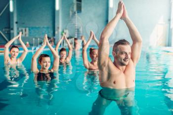 Women aqua aerobics class on training in water sport center, indoor swimming pool, recreational leisure