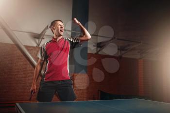 Male winner with racket, table tennis. Ping pong championship, high concentration sport