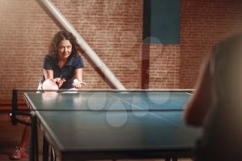 Table tennis, female player with racket on serve. Ping pong training indoor, high concentration sport game
