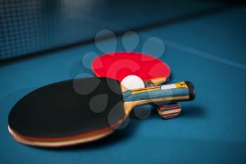 Two tennis rackets and ball on the table closeup, game concept. Ping pong sport equipment
