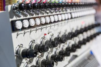 Professional sewing machine closeup, nobody. Textile fabric. Factory production, sew manufacturing, needlework technology