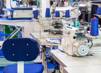 Sewing machine, nobody, clothing sew on fabric. Factory production, cloth manufacturing, dressmaker workplace