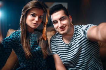 Portrait of young love couple in nightclub. Night relaxation and lifestyle