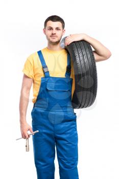 Tire serviceman isolated on white background, repairman with tyres