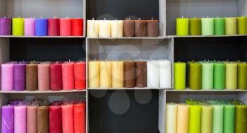 Colorful candles on shelf in decoration shop. Many candlelights for relax