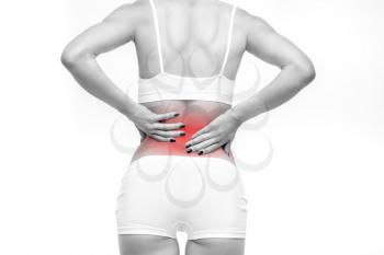 Back or lumbar pain, female person with backache on white background. Woman in white lingerie, spine problem, medical advertising or concept