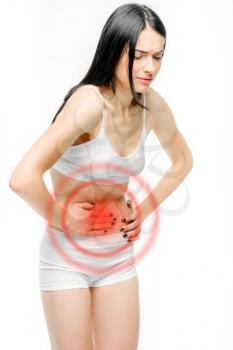 Abdominal pain, woman with problem during menses, white background. Female person in white lingerie, medical advertising or concept