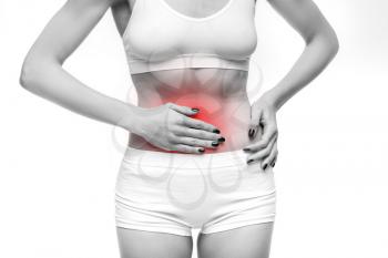 Stomach pain, woman with problem during menses, white background. Female person in lingerie, medical advertising or concept