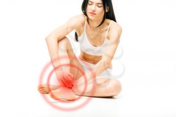 Joint pain, female person with leg stretching, red nerve effect, white background. Woman in lingerie, medical advertising or concept