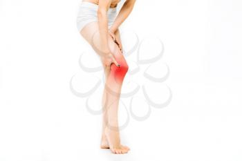 Joint ache, female person with leg stretching, source of pain effect, white background. Woman in lingerie, medical advertising or concept