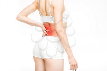 Back pain, woman with backache on white background. Female person in white lingerie, medical advertising or concept