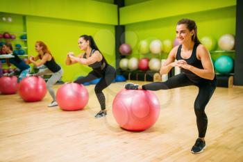 Women group with big balls, fit exercise in motion, fitness workout. Female sport teamwork in gym. Aerobic class