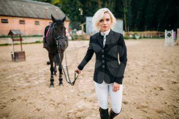 Equestrian sport, female jockey and horse. Brown stallion, horseback riding, leisure with animal