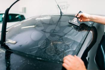 Male specialist work with window, car tinting film installation process, installing procedure,