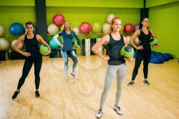 Women group with balls on fitness training. Female sport teamwork in gym. Fit exercise, aerobic