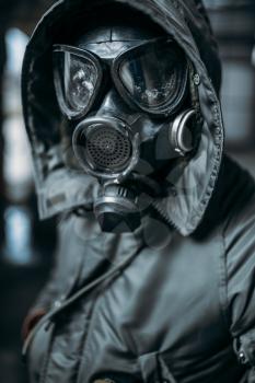 Stalker concept, male person in gas mask, radiation danger. Post apocalyptic lifestyle, doomsday, horror of nuclear war