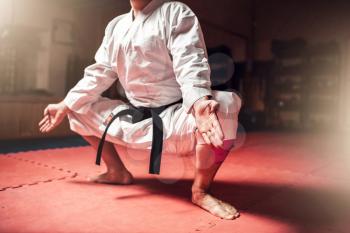 Martial arts, karate master in white kimono and black belt meditation training in gym