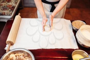 Male chef hands and dough on wooden table. Homemade strudel cooking