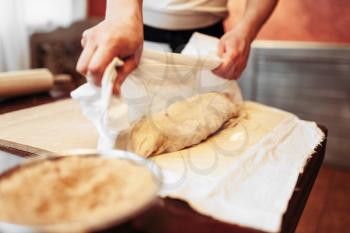 Male chef prepares apple strudel for baking. Homemade sweet dessert, preparation process, pastry cooking