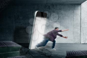 Phone addicted people concept. Man jumps out from a glowing smartphone screen. Scaling effect