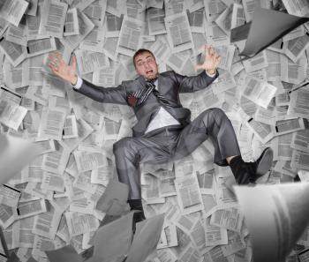 Crazy businessman among the pile of papers and reports, bureaucracy and paperwork in business