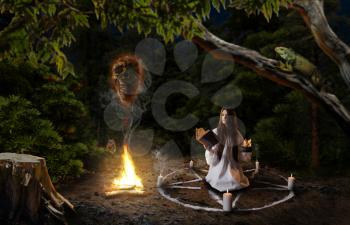 Witch in white shirt calling spirits of dead people, pentagram circle with candles, dark magic ritual in the forest, witchcraft. Occultism and exorcism