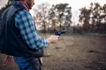 Cowboy with revolver, front view, gunfight on texas ranch, western. Vintage male person with gun, wild west adventure