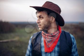 Portrait of brutal cowboy in leather jacket and hat, western. Vintage male person, retro american fashion in wild west style