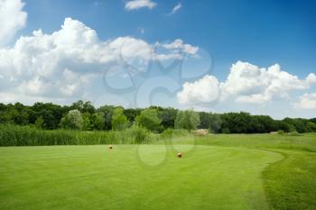 Two balls on golf course, nobody. Green meadow in sport club, trimmed lawn for game, playground