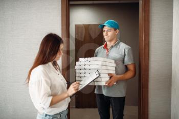 Pizza delivery boy takes a tip for speed from female customer, quick delivering service. Deliver from pizzeria and woman at the door
