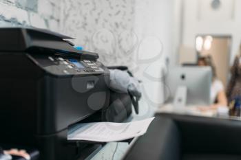 Copier with contract, equipment in business office, Secretary at the workplace on background. Printer on the table in company