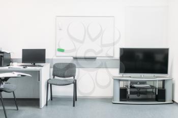 Comfortable business office in white tones with modern equipment, nobody. Workplace for presentations