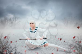 Anime style blonde girl with sword in a snowy field. Cosplay woman, japanese culture, doll with blade in cold tones, cityscape on background