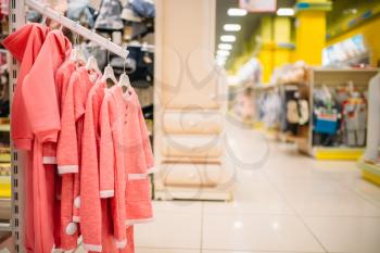 Store for newborns, showcase in cloth department, nobody. Baby wear in shop of goods for infants