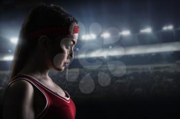 Female boxer in red sportswear before the fight, side view,. Woman on boxing ring