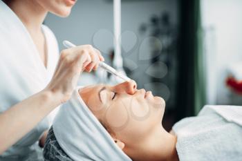 Beautician makes rejuvenation procedure to female patient, cosmetology clinic. Facial skincare in spa salon, health care