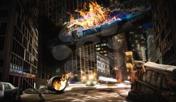 Air crash concept. Burning fuselage of the aircraft crashed into a building, exploded engine on the road, city destruction