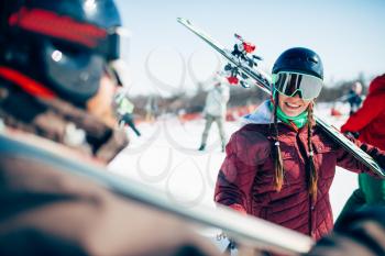 Skiers with skis and poles in hands, winter active sport. Skiing from mountains, extreme lifestyle