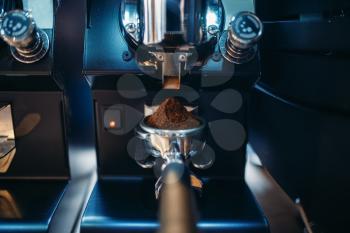 Coffee machine with fresh ground grains closeup, nobody. Professional espresso preparation, restaurant, cafe or cafeteria business tools
