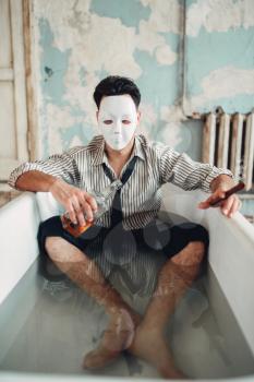 Drunk businessman with cigar in hand sitting in bathtub, suicide man concept. Problem in business, stress