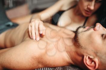 Sexy couple in underwear hugs in bed after sex, erotica. Erotic scene, sexual relationship