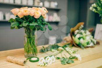 Fresh rose bouquet composition in flower boutique, nobody. Floral business, florist workplace in shop