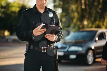 Cop in uniform with notebook in hands check the car on road. Law protection, car traffic inspector, safety control job