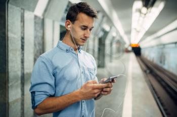 Phone addict man using gadget in subway, addiction problem, social addicted people, modern lifestyle