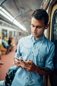 Phone addict man using gadget in metro, addiction problem, social addicted people, modern lifestyle