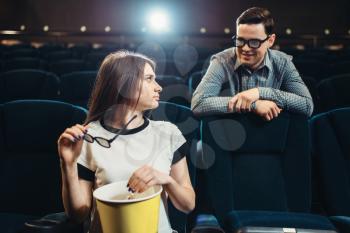 Young man and woman meet in the cinema before the movie. Showtime, entertainment industry