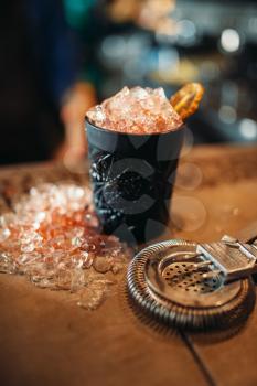Black glass with ice, cold crystals on bar counter closeup, nobody. Refreshing of alcoholic drink, 