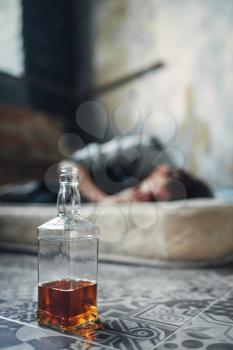Male alcohol addict sleeping on mattress. Addiction concept, drunk addicted people