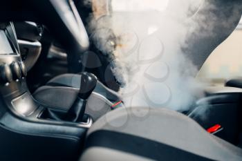 Professional dry cleaning of car interior with steam cleaner. Carwash service, vehicle salon hygiene
