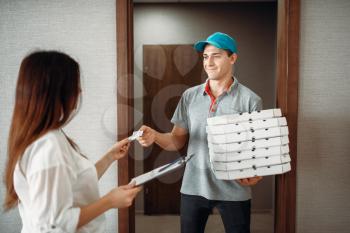 Pizza delivery boy takes a tip for speed from female customer, quick delivering service. Deliver from pizzeria and woman at the door
